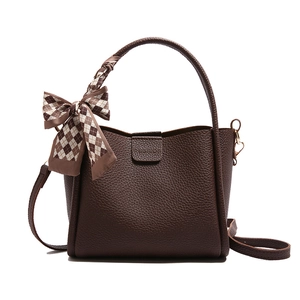 Deep brown pebble leather bucket bag with plaid silk scarf wrap and golden hardware