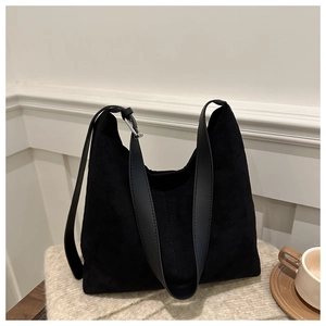 Minimalist black oversized tote bag in matte suede finish with adjustable strap