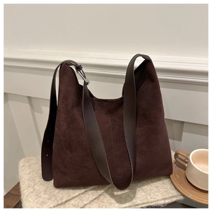 Large brown suede tote bag for women with wide shoulder strap on beige knit fabric