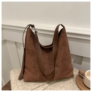 Brown vintage suede tote bag with large capacity for women on cozy knit background
