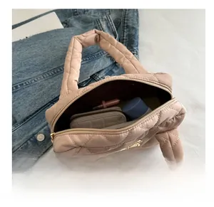 Pink quilted handbag interior view showing large capacity for wallet and cosmetics
