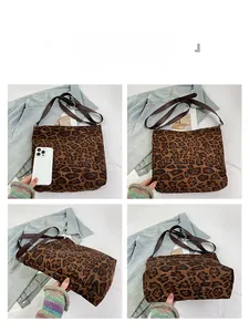 Detailed views of leopard print tote bag with brown leather straps and phone for scale