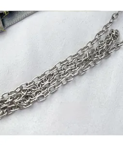 Macro view of silver metal chain strap with oval links for crossbody evening bags