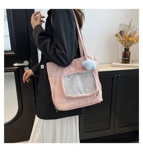 Pink nylon ita bag featuring a transparent PVC window and a blue star plush keychain