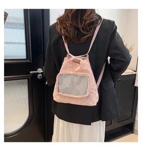Detail of pink nylon tote bag featuring a mesh window and adjustable shoulder straps