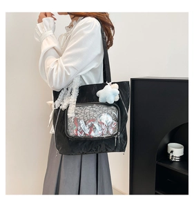Close-up of black Ita-bag featuring transparent PVC pocket and cute lace details