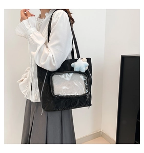 Detail of black nylon tote bag with transparent display window and blue star charm