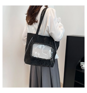 Close-up of black nylon tote bag with transparent PVC window and sleek metal zipper detail