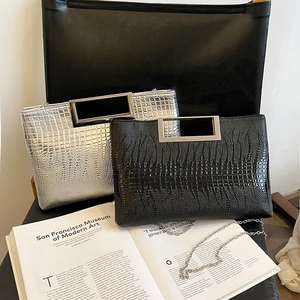 Elegant crocodile embossed evening bag in black and silver with metal handle and chain