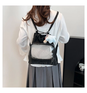 Detail view of water-resistant nylon tote bag featuring a transparent PVC front pocket