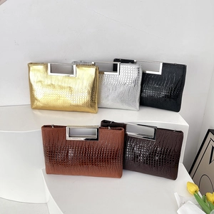 Fashion crocodile pattern handbags with metal handles in five elegant colors on display
