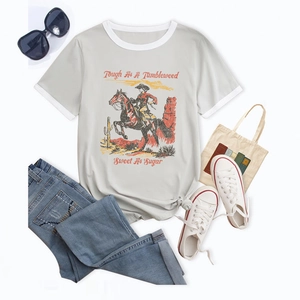 Detail of color block T-shirt with vintage cowboy print, flat lay styling with jeans