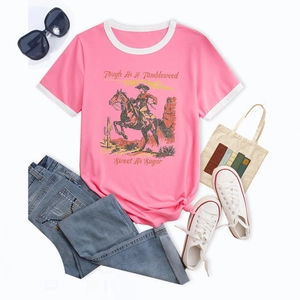 Flat lay of pink contrast trim T-shirt with vintage western desert print and denim jeans
