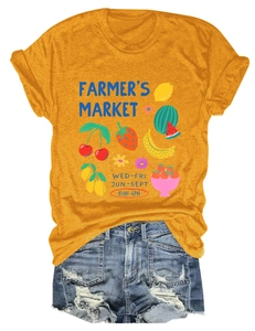 Flat lay of yellow Farmer's Market fruit graphic T-shirt with distressed denim shorts