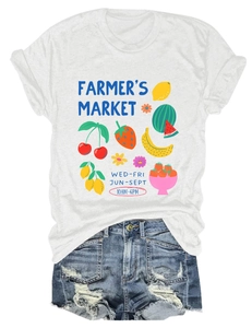 Flat lay of white cotton t-shirt with colorful fruit market graphic and denim shorts