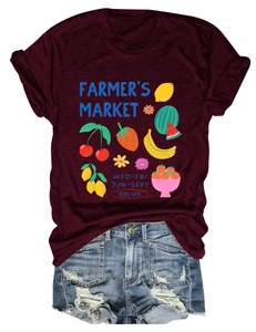 Detail of burgundy T-shirt with fruit graphics and distressed denim shorts