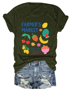 Flat lay of olive green Farmer's Market fruit graphic T-shirt with distressed denim shorts