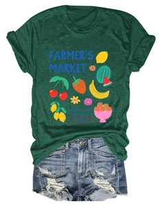 Flat lay of a green Farmer's Market cotton T-shirt paired with ripped denim shorts