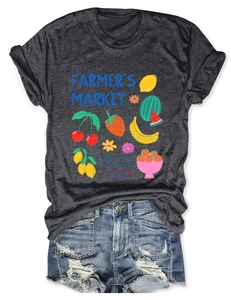 Flat lay of charcoal grey t-shirt with fruit print and ripped light blue denim shorts