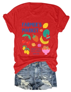 Flat lay of red cotton t-shirt with fruit market graphic and distressed denim shorts