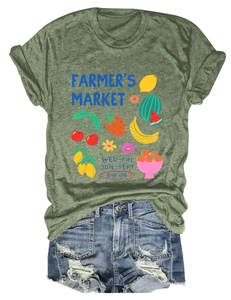 Flat lay of a green Farmer's Market fruit graphic T-shirt with ripped denim shorts