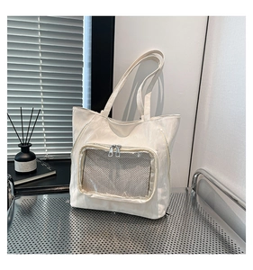 Detail of white PU tote bag with transparent mesh zipper pocket and wrinkled texture
