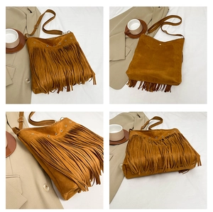 Detail shot of bohemian tan suede bag featuring long fringes and metal grommet accents