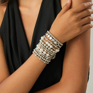 Detail of layered bracelet set with silver metal beads and white imitation pearls