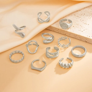 Detail of 11-piece minimalist silver ring set featuring geometric patterns on stone