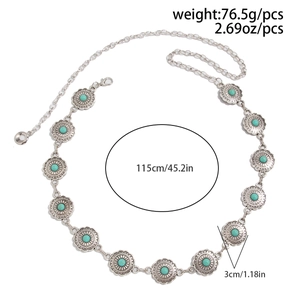 Detail of bohemian waist chain featuring turquoise beads and carved metal discs