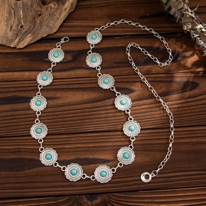 Bohemian silver metal waist chain belt with turquoise flower pendants on wooden surface