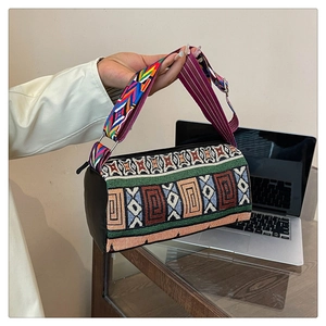 Détail du sac seau bohème avec motifs ethniques tissés et large bandoulière décorée