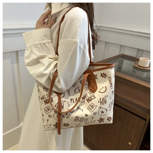 Detail of the casual graffiti print tote bag with brown straps and stylish bear patterns