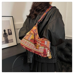 Detailed close-up of a bohemian woven shoulder bag with colorful tassels and ethnic patterns