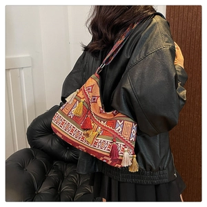 Close-up of bohemian shoulder bag with colorful tassels and jacquard geometric pattern