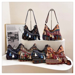 Detail view of ethnic tote bags with geometric patterns and colorful tassel decorations