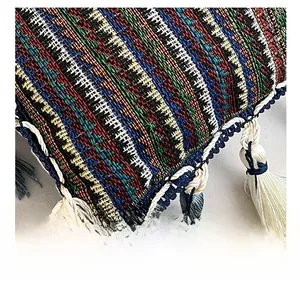 Detailed close-up of intricate ethnic weave patterns and decorative tassel fringe on the tote