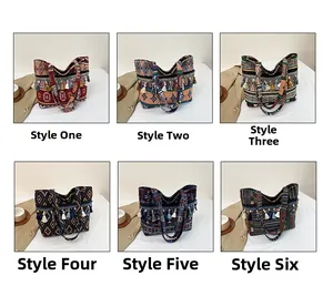 Detailed view of woven ethnic tote bags with geometric patterns and colorful tassels