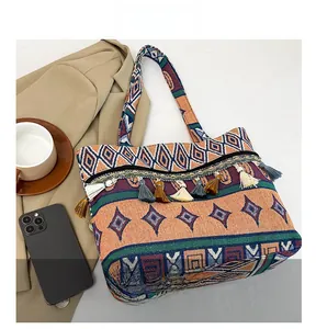 Detailed close-up of bohemian woven bag with colorful geometric patterns and decorative tassels