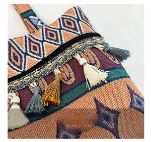 Detail of bohemian fabric bag with colorful geometric patterns and woven tassels