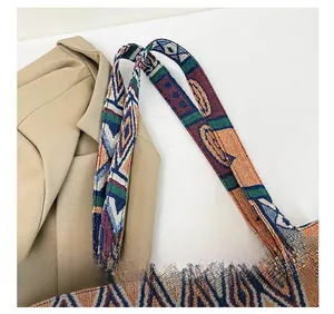 Close-up of colorful woven shoulder strap with geometric patterns on ethnic crossbody bag