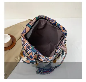 Detail view of ethnic tote bag showing large capacity interior and tassel fringe trim