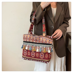 Detail of colorful boho tassels and geometric woven texture on this ethnic tote bag