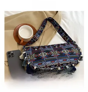 Detail of bohemian ethnic crossbody bag featuring colorful jacquard fabric and long tassels