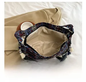 Detailed interior of ethnic woven crossbody bag with zipper and large capacity storage