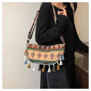 Close-up of bohemian tassel shoulder bag with colorful geometric woven patterns