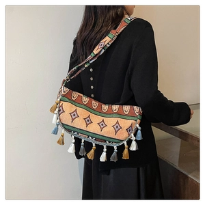 Close-up of vintage ethnic crossbody bag with geometric jacquard and colorful tassels