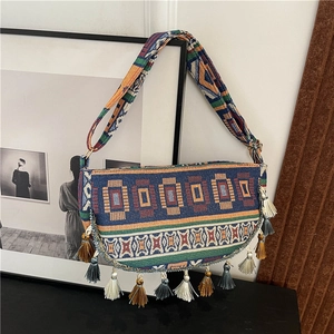 Ethnic bohemian semi-circle crossbody bag with geometric textures and colorful tassels