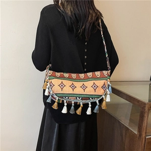 Ethnic style woven crescent crossbody bag with colorful tassels and geometric patterns