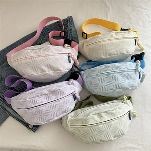 Minimalist woven chest bags in five pastel colors with adjustable straps on white fabric